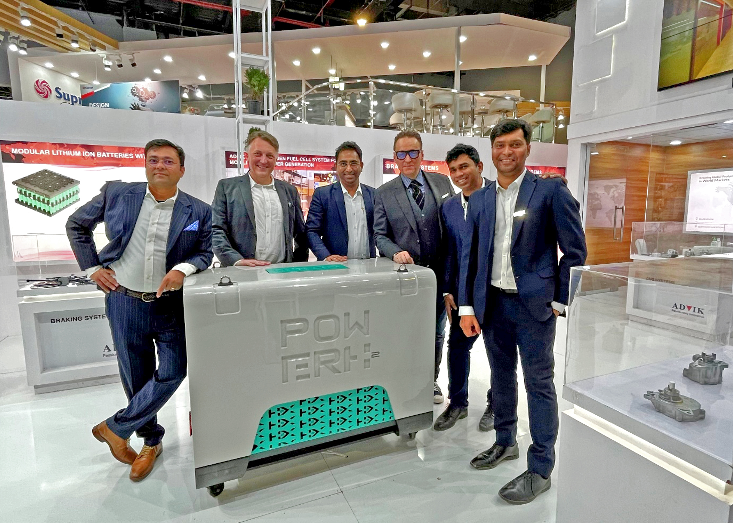 H2X Global Co-Founders Brendan Norman and Chris Reitz pose for a photo with Advik team (India). In front of them is the Hydrogen Fuel Cell Generator in 2kW.